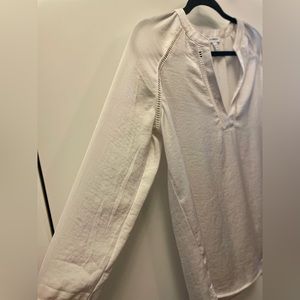 White Express blouse with 3/4 length sleeves, button on sleeves, and cut outs